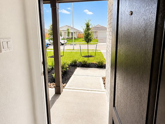 Welcoming front entry with natural light and a peaceful neighborhood view.