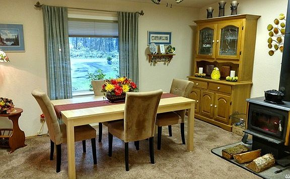 This is a flex room off the entry, it is right off the kitchen so they chose to use as a dining room.  Makes a lovely setting with the window and the woodstove.