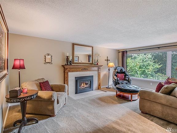 Brand New Remote Controlled Fireplace with Custom Hearth and Mantle cozies up the living room.