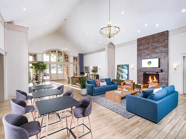 Bright, inviting clubhouse lounge designed for casual conversations, productivity breaks, or simply relaxing fireside.