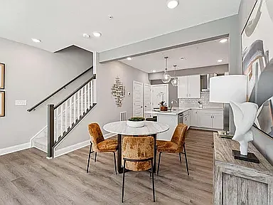 The rear-load garage entry opens directly into the kitchen area, providing easy access to the storage and pantry closets.