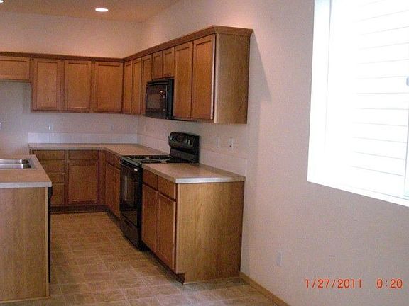 Kitchen has an island with the sink.