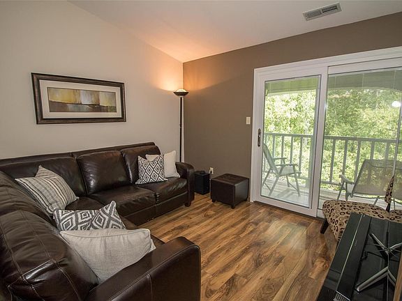 Another view of the living room and deck. Beautiful floors.