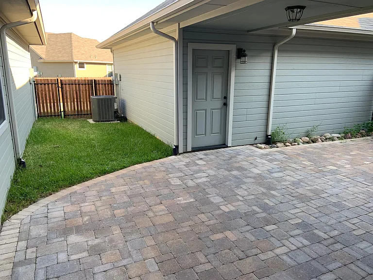 Paved backyard patio, yard maintained by HOA.