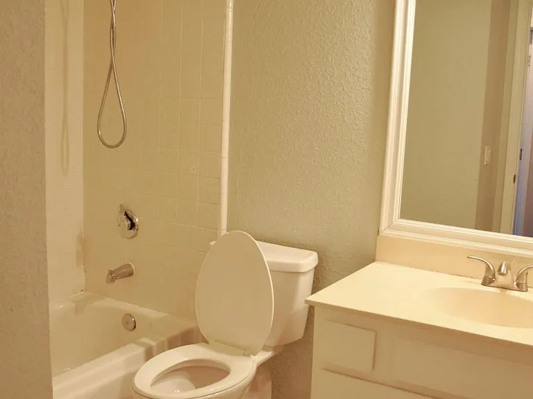 Guest bathroom on right before bedrooms. There is a large storage closet at the end of the hall