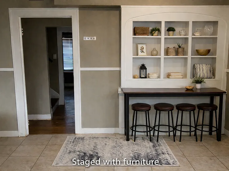 Kitchen has built in cupboard for extra storage and space for breakfast area
