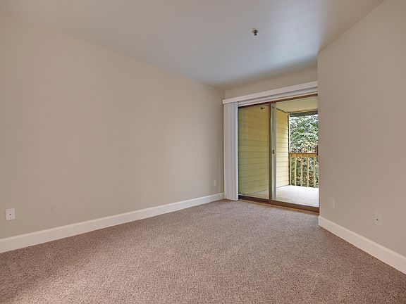 Large living area with sliding glass doors out to the balcony