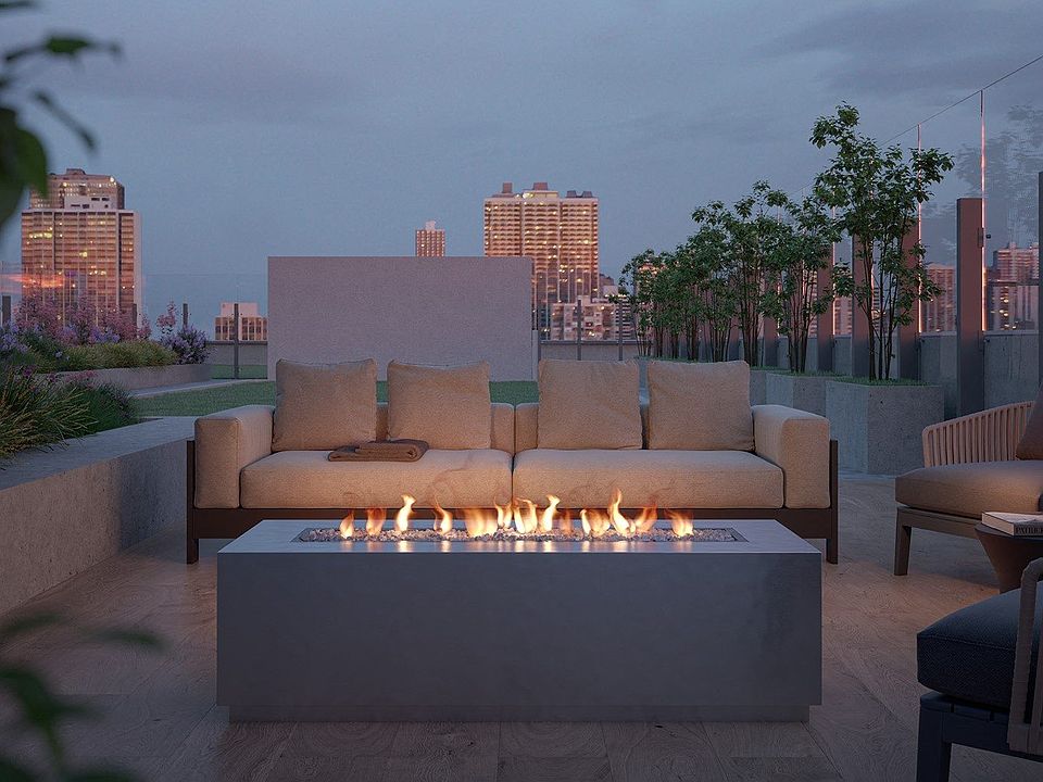 Relax on the rooftop couch by the fire, the perfect spot to unwind and enjoy the sunset views.