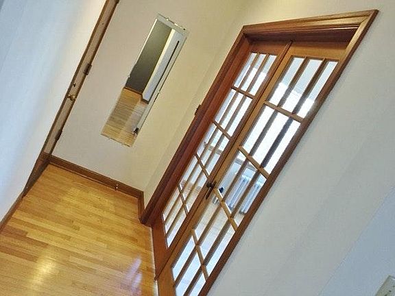 Entryway reverse with French doors to front bedroom/office.