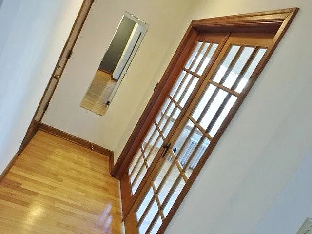 Entryway reverse with French doors to front bedroom/office.