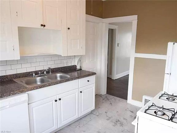 Bright kitchen with range, refrigerator, and dishwasher.