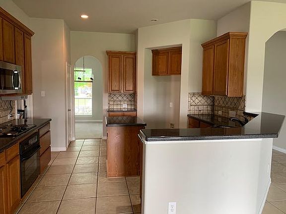 Electric Range, built-In Microwave, Nice Oven and lots of cabinet space opens to formal dining area in the front of the house.