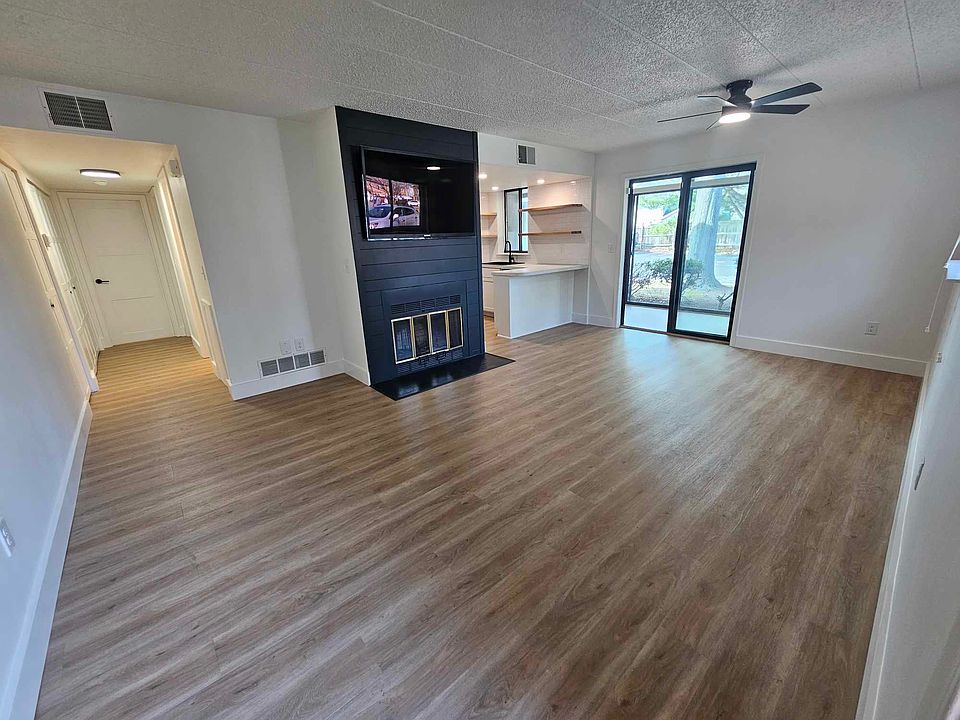 Living room with picture sliding doors that lead to the sunroom.