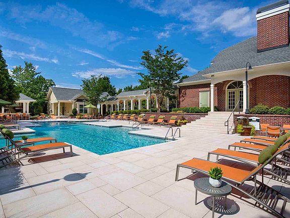 Resort-style pool and expansive sundeck with lounge seating