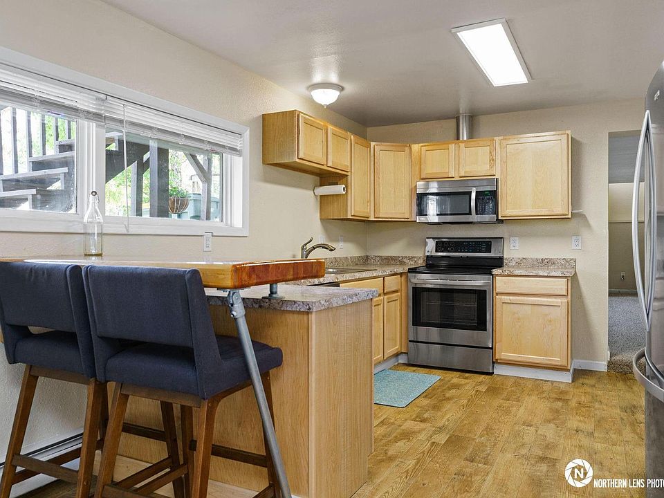 Kitchen with all stainless steel appliances and custom breakfast bar