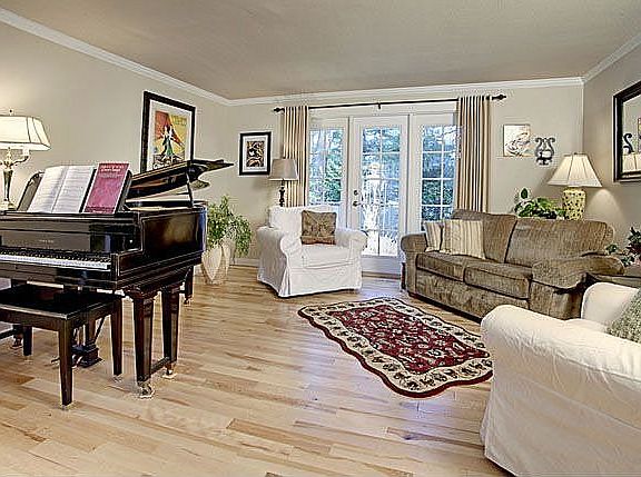 Formal living room with French Door/window combination looking out over the back yard. New hardwood 