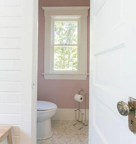 Victorian lavatory white marble floor in laundry room. Not shown large floor 12 foot cabinet matching kitchen cabinets at entrance adding plenty of storage to this sophisticated apartment.