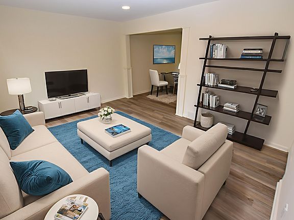 Spacious living room with great natural lighting and warm neutral colors