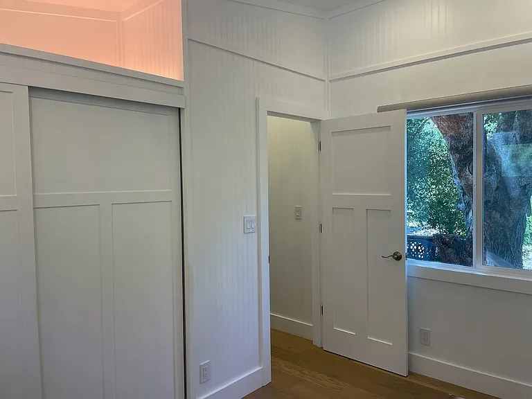 Bedroom fits a queen size bed with 2 small night stands. Extra storage in loft above closet.