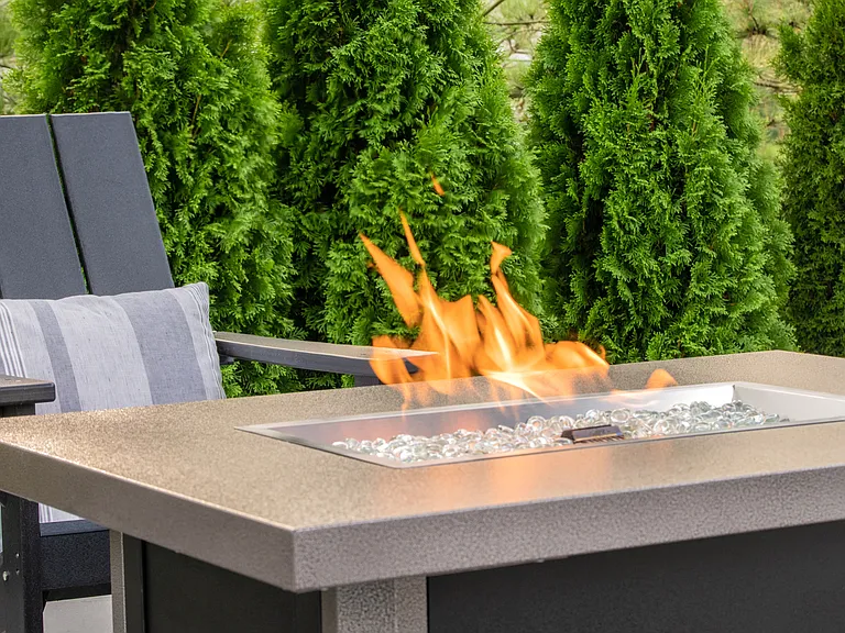 Gather around our modern outdoor fireplace for cozy evenings with friends and neighbors, professionally operated by Highlands Vista Group.