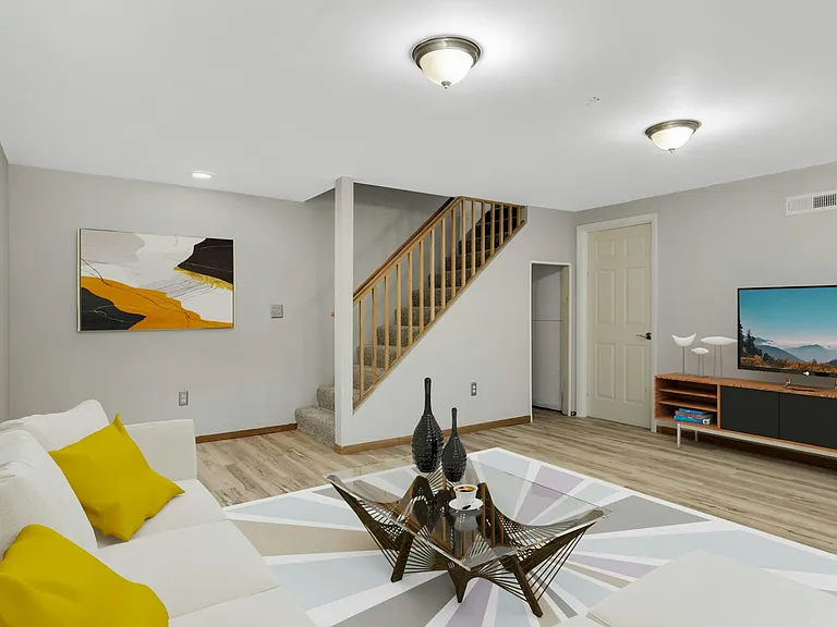 Alternate staged view of lower level showing flexible living space