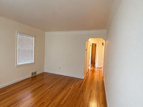Living room from the opposite angle and view of hallway.