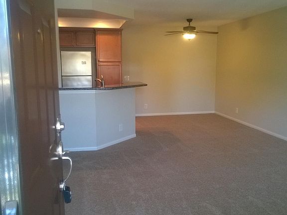 Living Room has neutral two tone paint and newer carpet inst