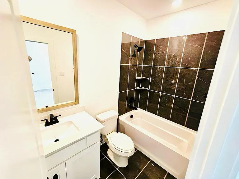 Bathroom featuring vanity and tub / shower combination