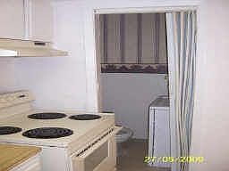 Kitchen with half bath downstairs, and stackable washer/dryer