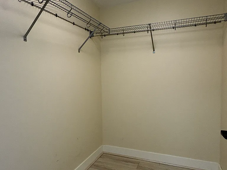 Primary bedroom walk-in closet