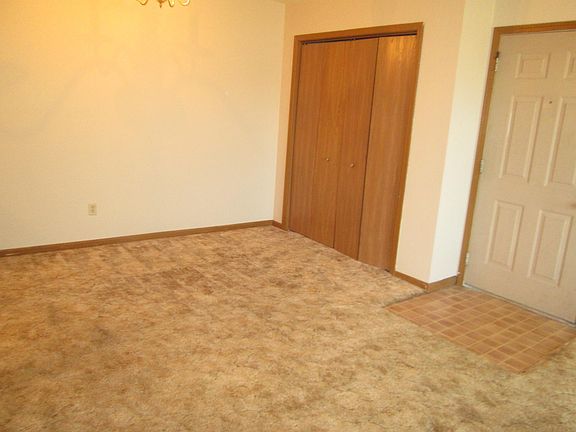 Dining area with a closet also shows the front door.