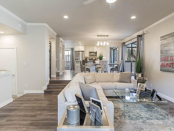 Main floor living room - open floor plan leads to dining and kitchen