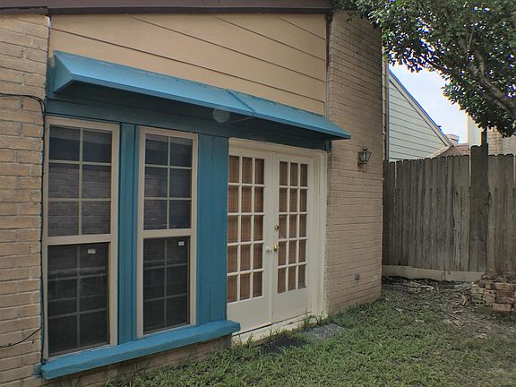 Outside of the living room, there is a patio space right behind the garage