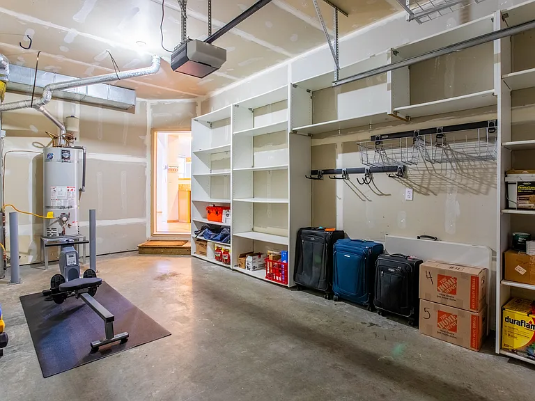 1-car garage with built-in storage shelves, and racks on the walls and ceiling for additional storage