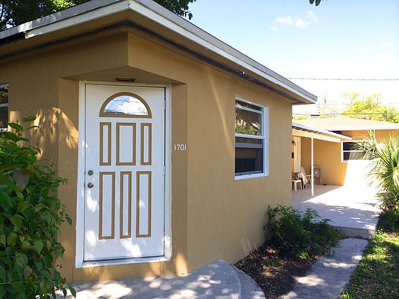 Front door and porch (covered area perfect for deliveries, where the mailbox is)