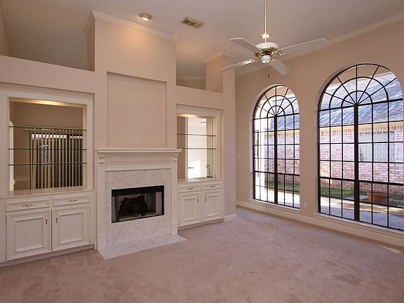 Large windows overlook the courtyard patio