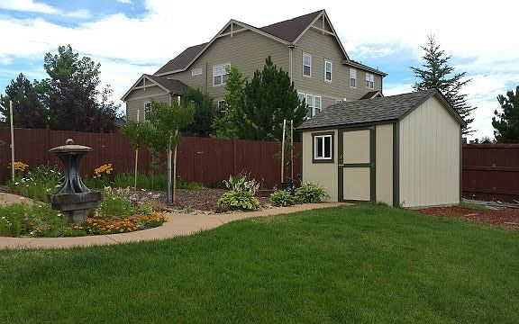 Beautiful Yard with a garden shed, fruit trees and garden
