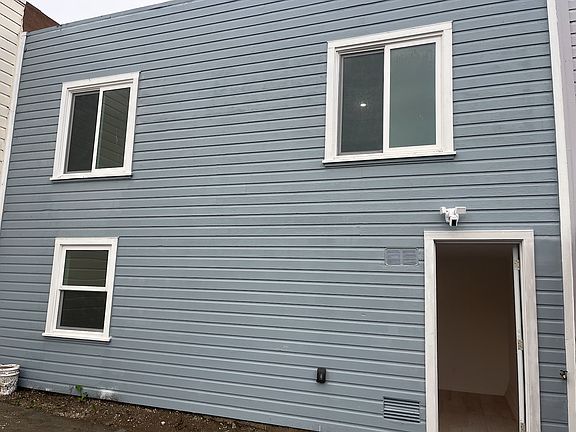 Back of the house with windows in each bedroom.