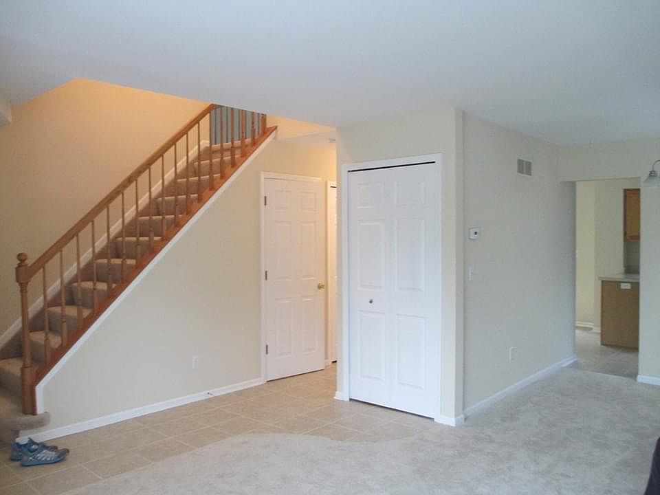 Living room prior to being painted, view towards the stairs.