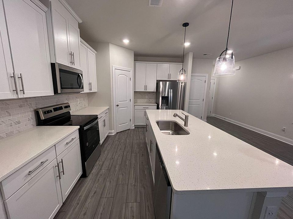 The kitchen island is massive and can accommodate 4 bar stools comfortably.