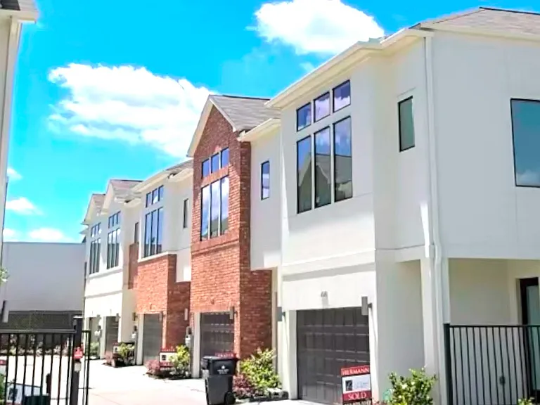 property featuring a brick facade in a gated community