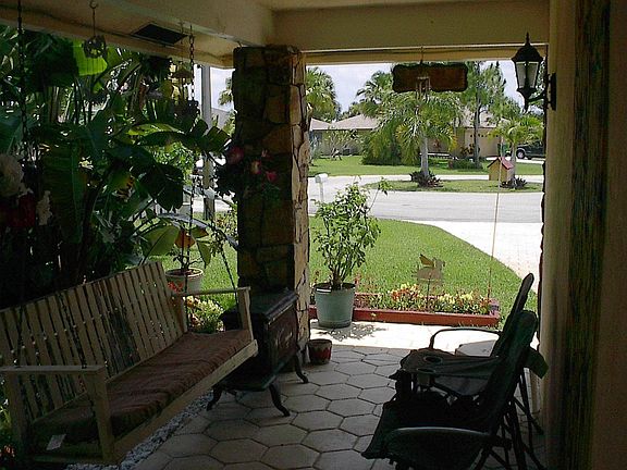 A covered front porch with a stamped concrete finish 