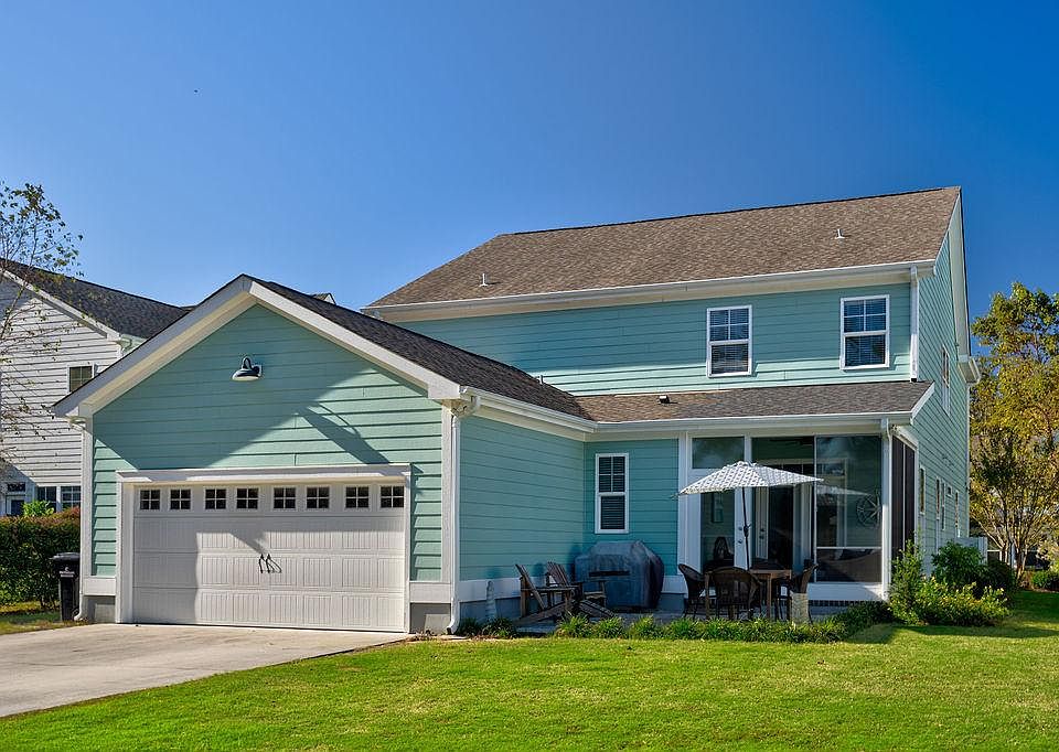 Exterior from backside, includes driveway, garage, zen patio and seasonal porch