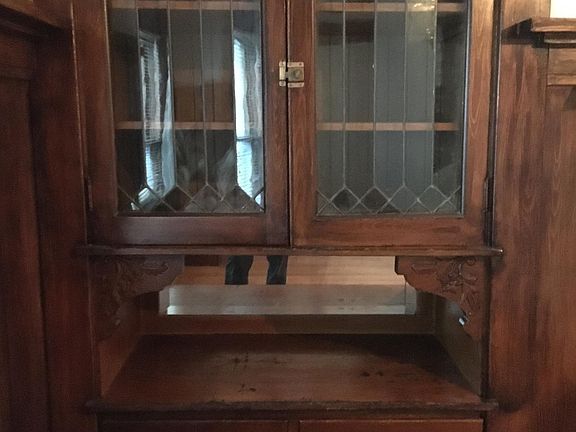 Original wood shelves and glass doors.