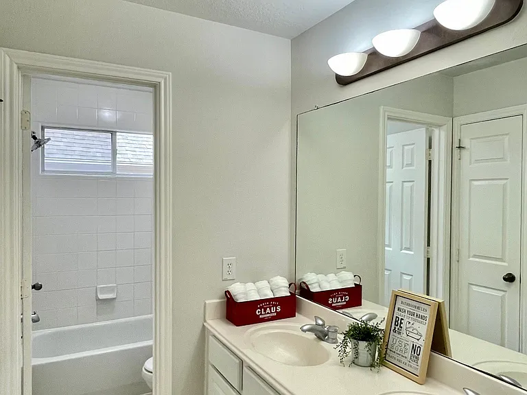 Secondary bathroom features dual sinks and convenient access from the guest bedrooms