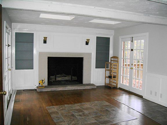 Family Room With Fireplace and 2 Sets of French Doors Leading To Back Decks.