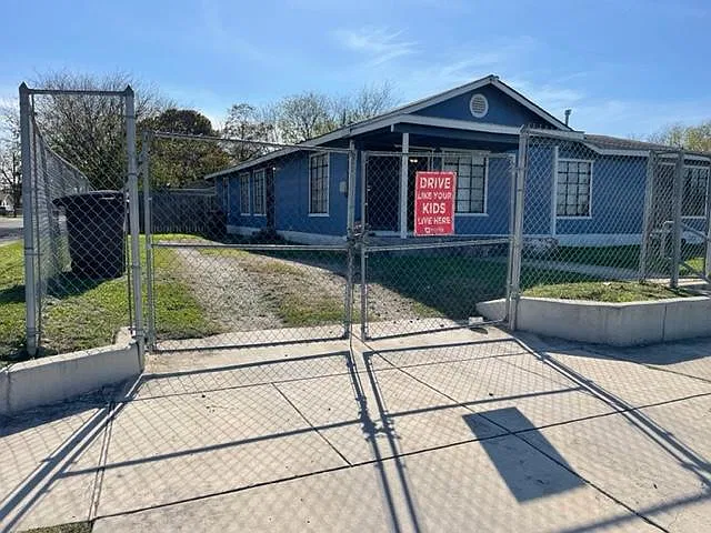 Front of house with long drive way for secure parking.