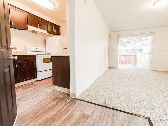 Lakewood Apartments - Pacific Walk Apartments - Entryway, Kitchen, Living Room, and Deck