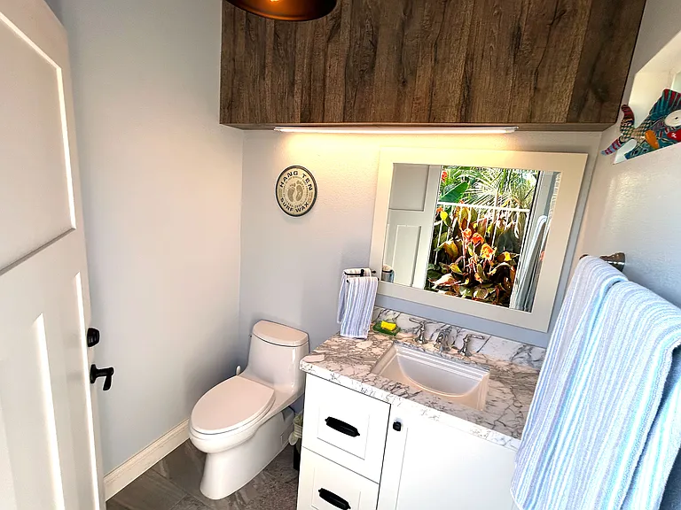 Enjoy ultimate convenience with a poolside bathroom featuring an attached outdoor shower_perfect for rinsing off after a swim or freshening up under the open sky. Refresh and relax without ever leaving the pool area!