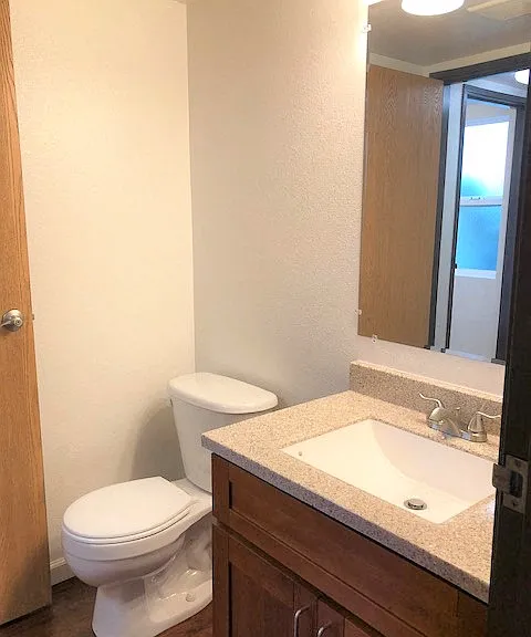 The Waterfront Apartments at Kahului bathroom sink, mirror, vanity, and toilet